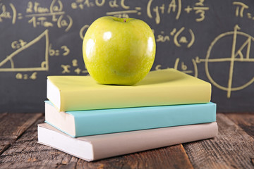 book and green apple