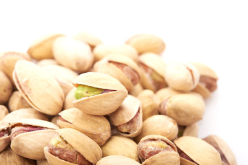 Heap of pistachios nuts isolated on the white