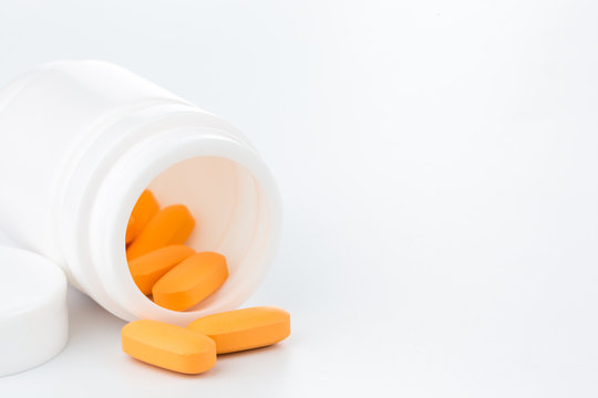 Orange Pills An Pill Bottle On White Background