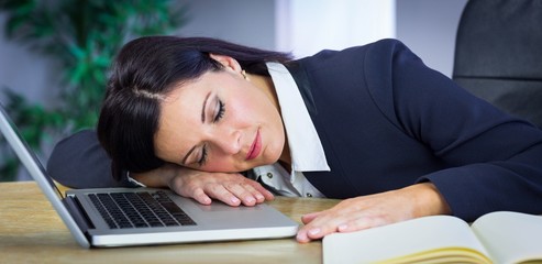 Businesswoman taking a nap on her desk