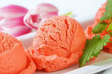 Scoops of fruit sherbet and fresh tulips