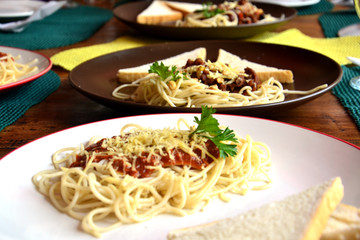 Three plates of spaghetti on plates photo