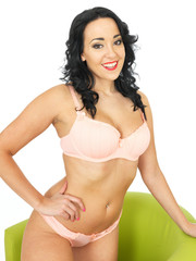 Obraz premium Portrait of a Beautiful Sexy Young Hispanic Pin Up Model Wearing Pink Lingerie