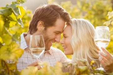 Fototapeta premium Young happy couple holding glasses of wine