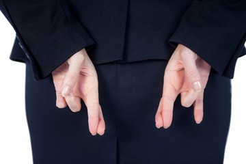 Obraz premium Close up pretty businesswoman with finger crossed 