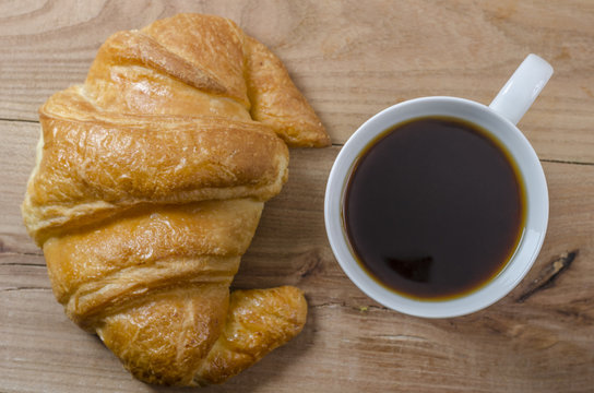  croissant with cup of coffee.