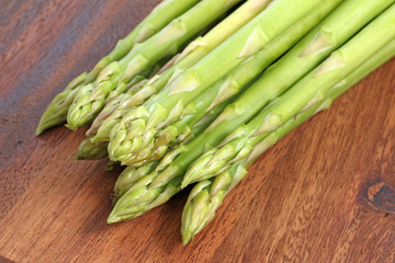 Fresh green asparagus on a wooden board