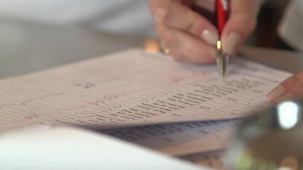 Member of staff checking name on list during a german golf tournament.