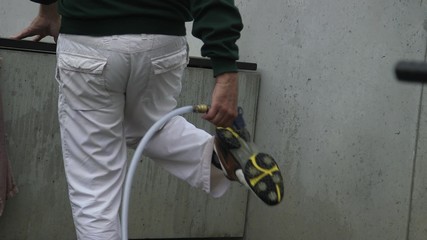  Aerial perspective of a golf player on Germany picking up two golf balls with his golf club on a sunny day.