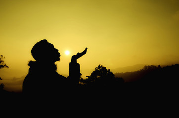 creative silhouette. man giving a kiss during sunset sunrise giving a kiss