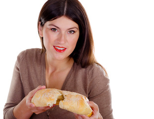 Young smiling woman holding homemade fresh baked bread