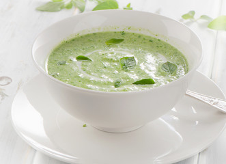 Creamy vegetable soup in  white bowl.