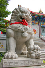 lion stepping world as stone statue at front chinese temple