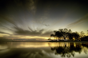 Naklejka na ściany i meble the beauty of sunset sunrise at the lagoon. Reflection on water and cloudy sky