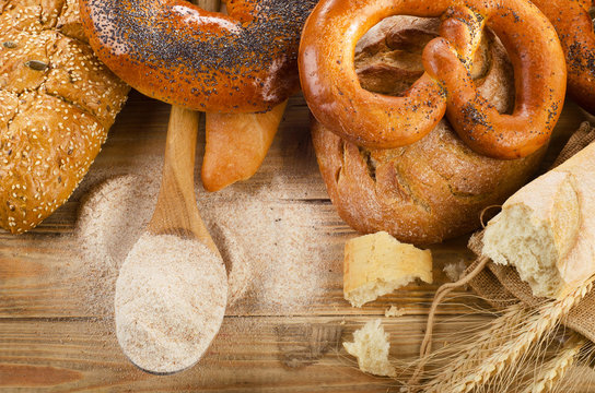 Fresh bread on  rustic wooden background.