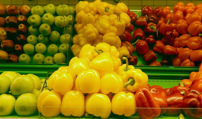 Yellow and red bell pepper on shelf in market