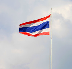 Image of waving Thai flag of Thailand with blue sky background.