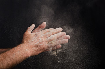 Obraz na płótnie Canvas Chef Hand with flour on black