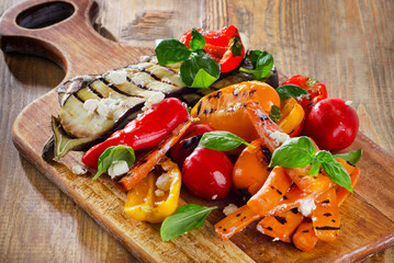 Grilled vegetables on   old wooden board.