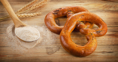 Freshly baked pretzels on  a old wooden table.