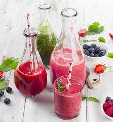 Healthy fresh smoothies on  a white wooden table.