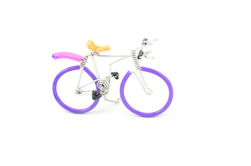 purple wired bicycle miniature placed from left to right isolated white background