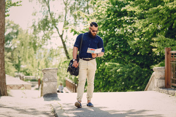 bearded man travels with map