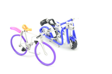 images focus to  purple wired miniature bicycle with blue scooter  isolated white background