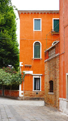 Fototapeta na wymiar Alley with orange ancient building