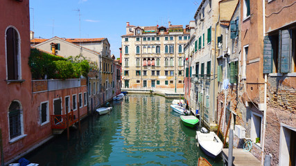 canal and boats with ancient buildings
