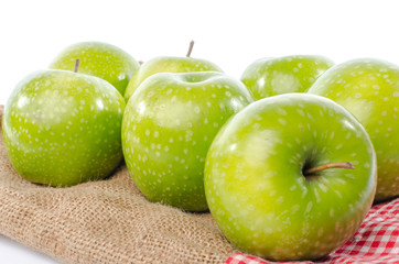 Fresh green apples on burlap bag