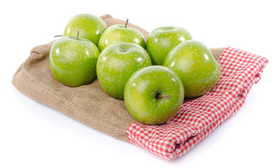 Fresh green apples on burlap bag