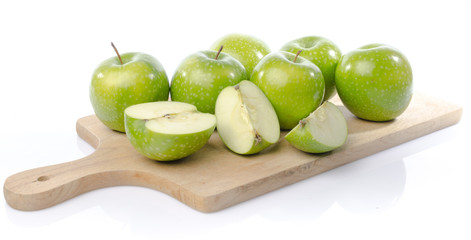 Fresh green apples on wooden board