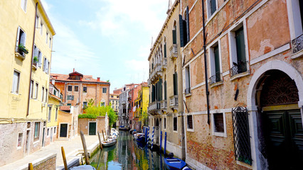 View of canal and boats with ancient architecture
