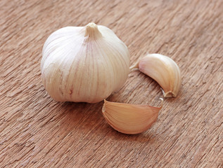 Organic garlic whole and cloves on the wooden background