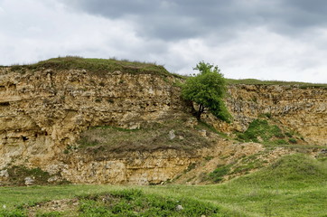 General view toward crag of sedimentary rock in the field, Ludogorie, Bulgaria  