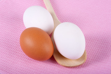 Three eggs on a pink table-cloth