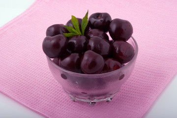 Sweet fresh cherries in a glass bowl