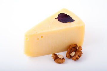 Tasty cheese with walnuts and a basil leaf