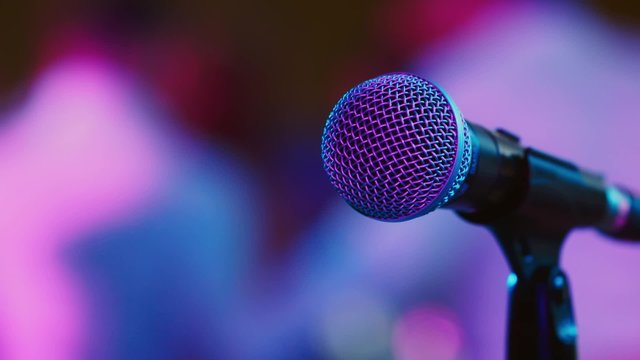 The microphone on the background of dancing people