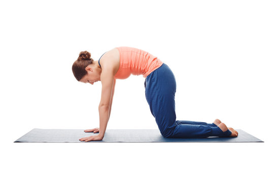 Beautiful sporty fit yogini woman practices yoga asana marjarias