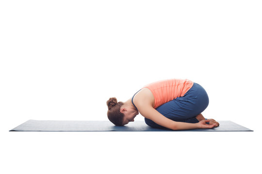 Beautiful sporty fit yogi girl practices yoga asana balasana