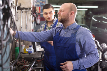 Two garage workmen near facilities