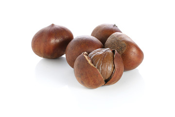 Chestnuts with chestnut leafs isolated on white