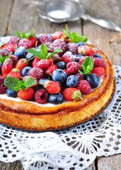Cottage cheese casserole with fresh strawberries, blueberries, raspberries and mint and powdered sugar