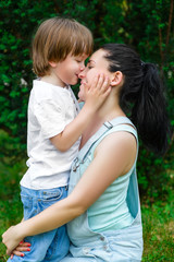 Fototapeta premium Loving son kissing his happy mother on the nose