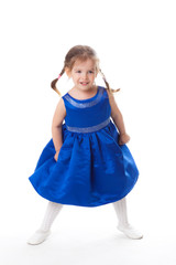 beautiful little girl in a blue dress dancing