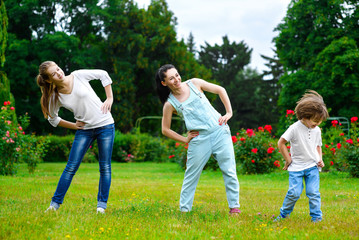 Naklejka na ściany i meble Portrait of happy family doing physical exercise or fitness in