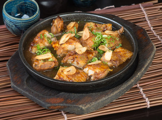 japanese cuisine. hot plate chicken on the background