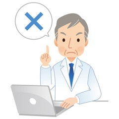 パソコンを操作する医者　バツサイン